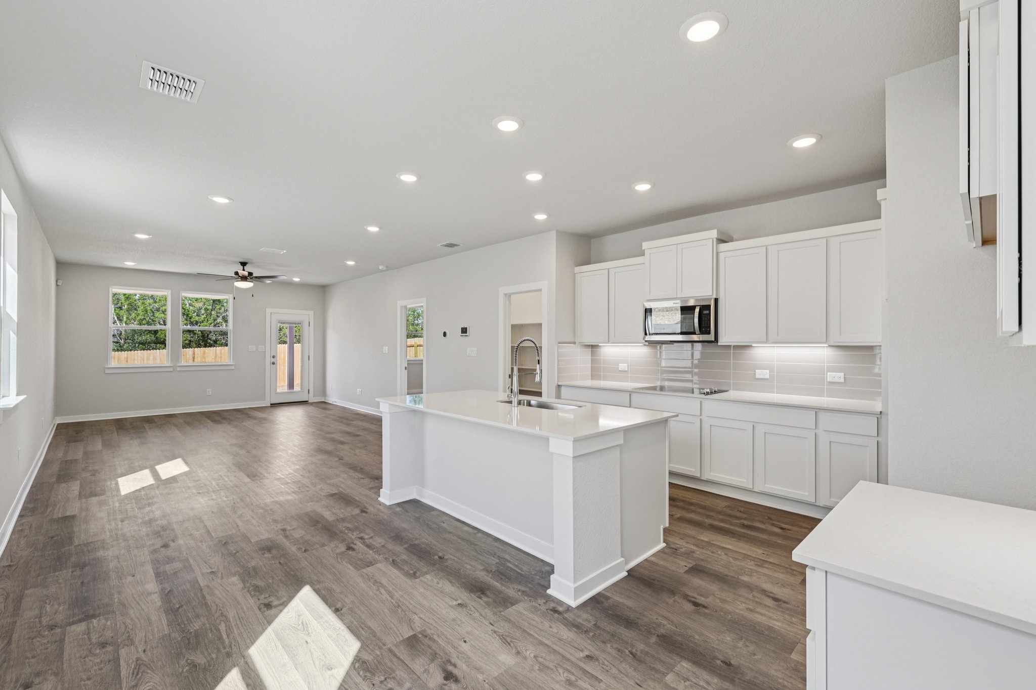A kitchen with white cabinets.