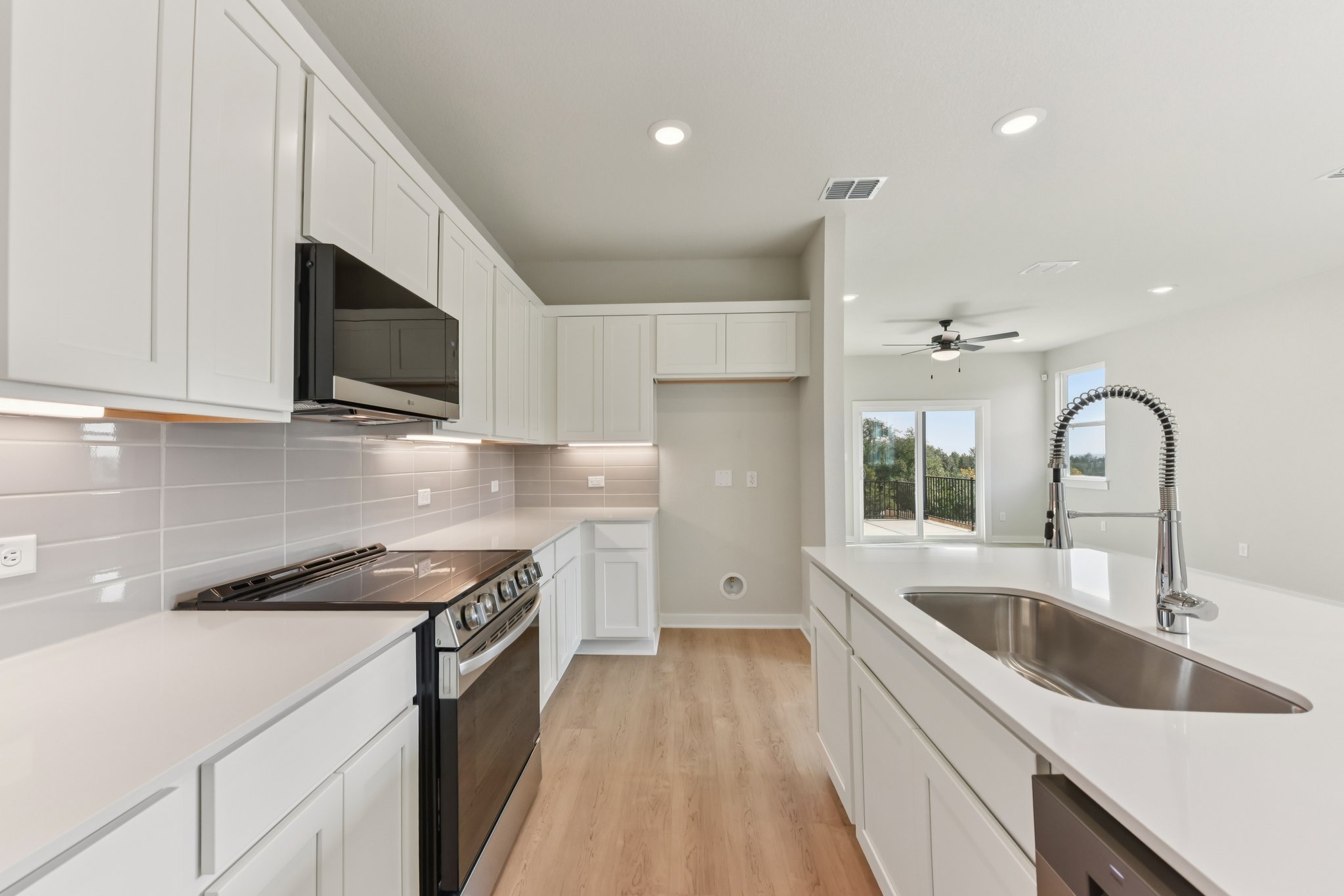 A kitchen with white cabinets.