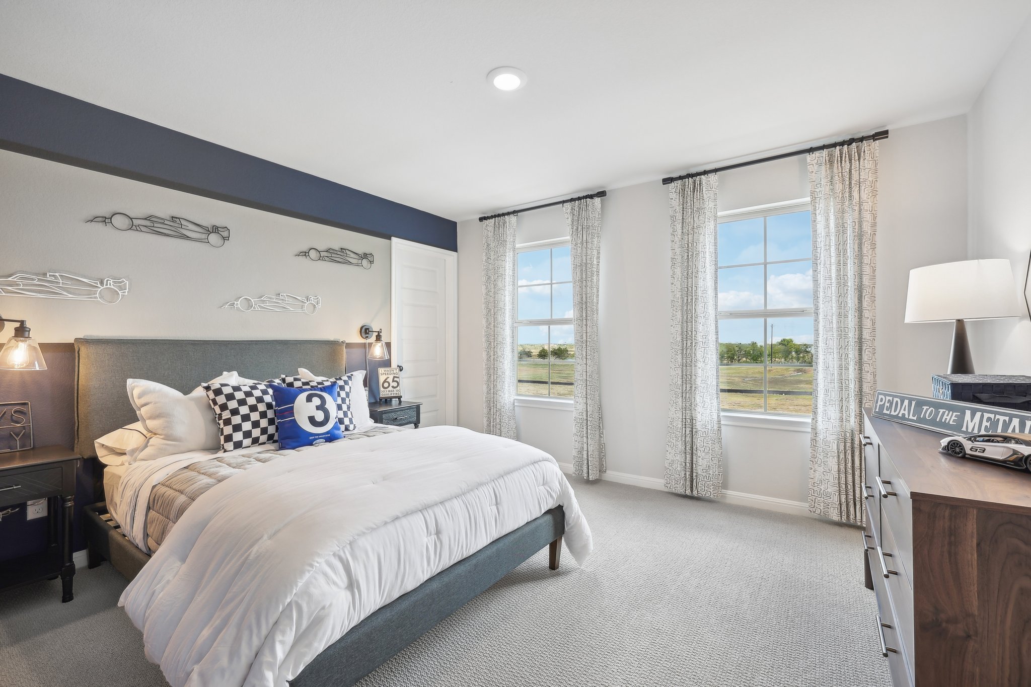 A bedroom with a large window.