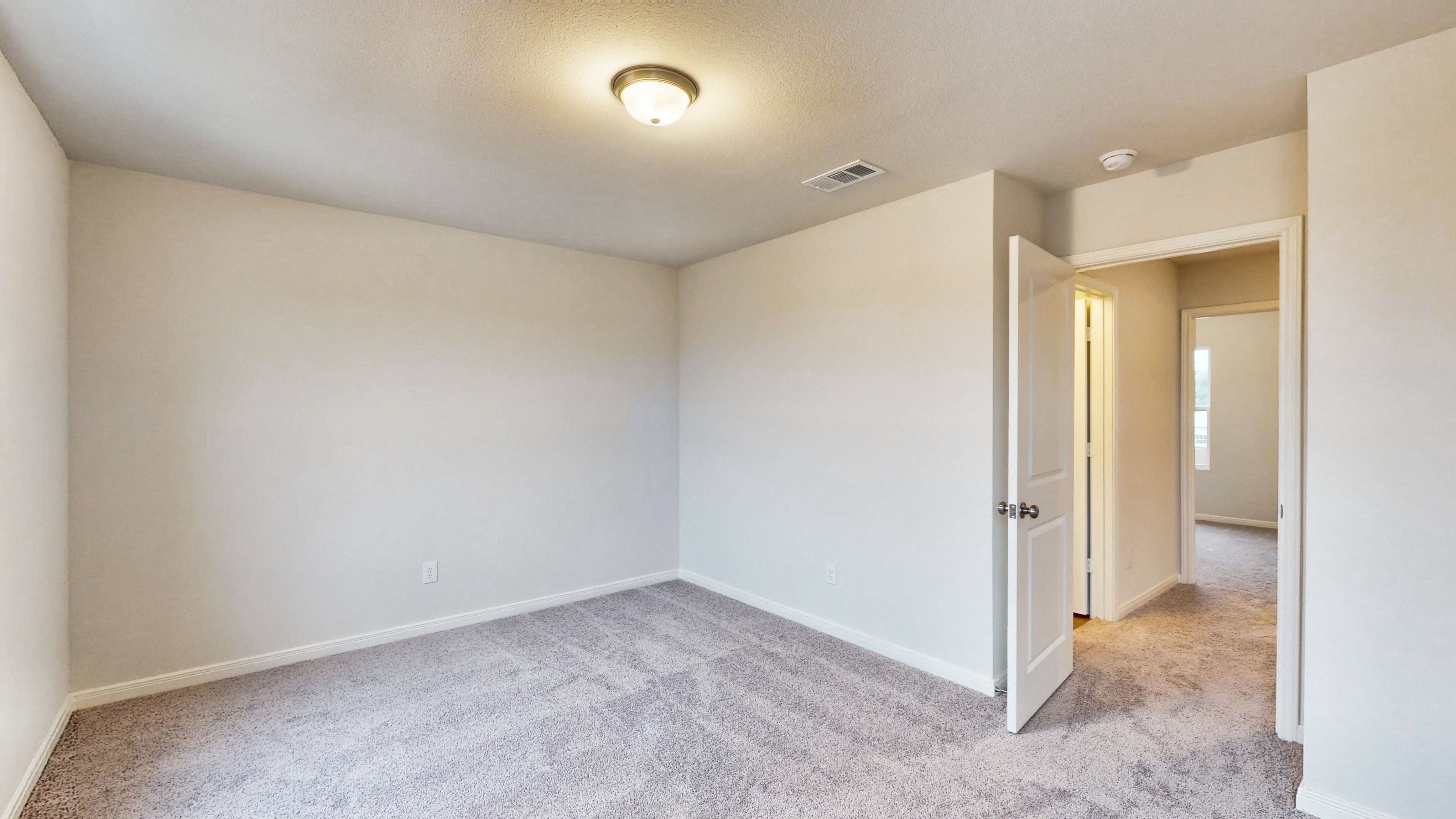 A hallway with white walls.