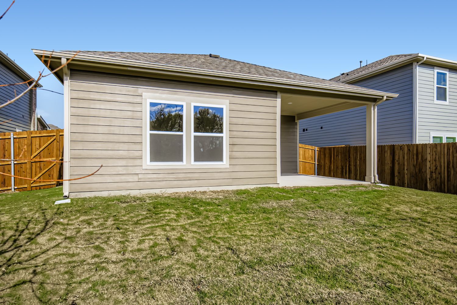 A house with a fence and grass.