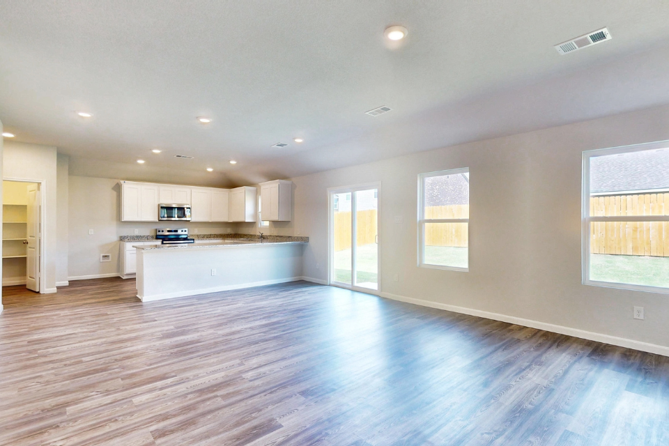 A large kitchen with white cabinets.