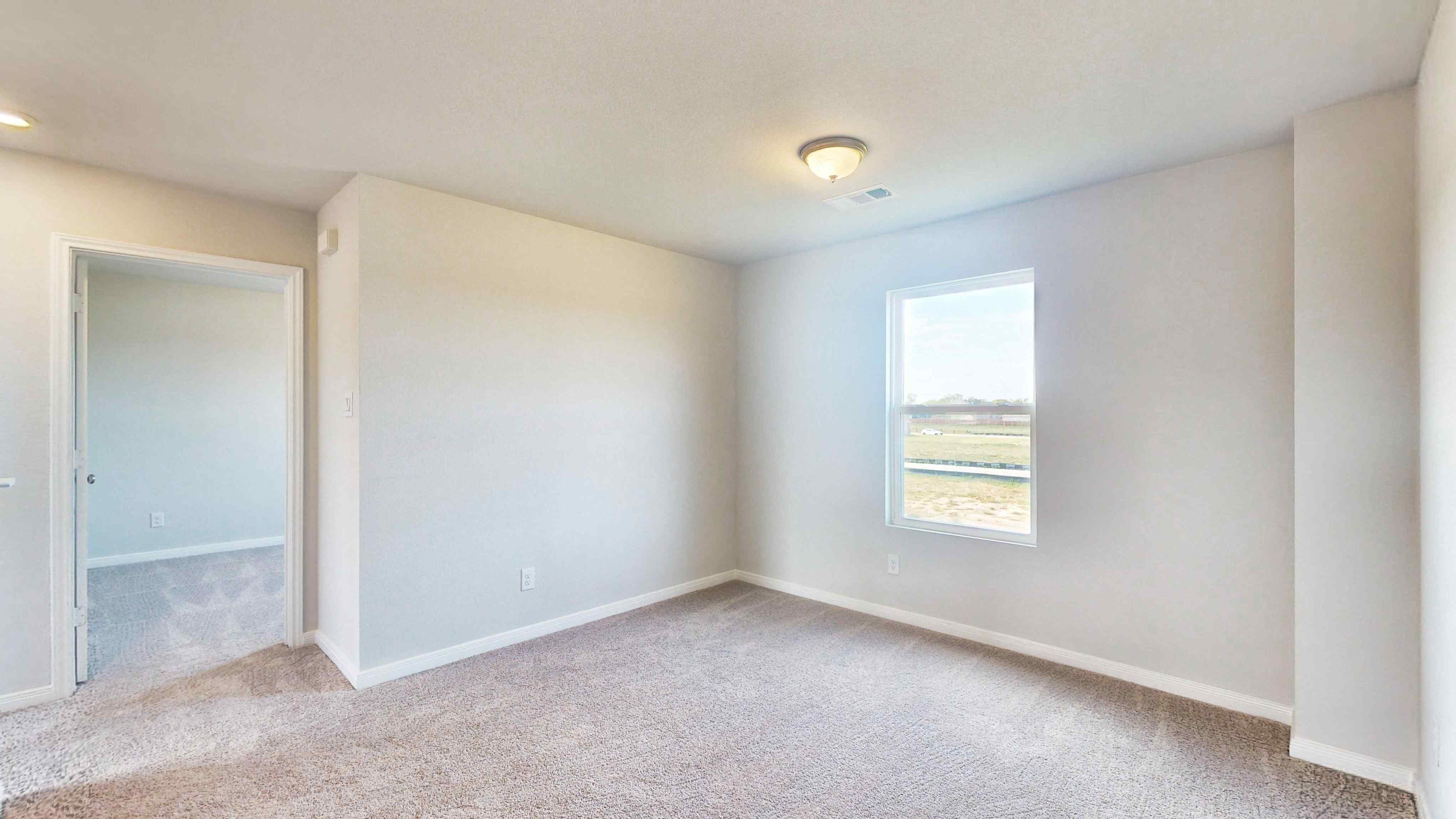 A room with a window and a door.