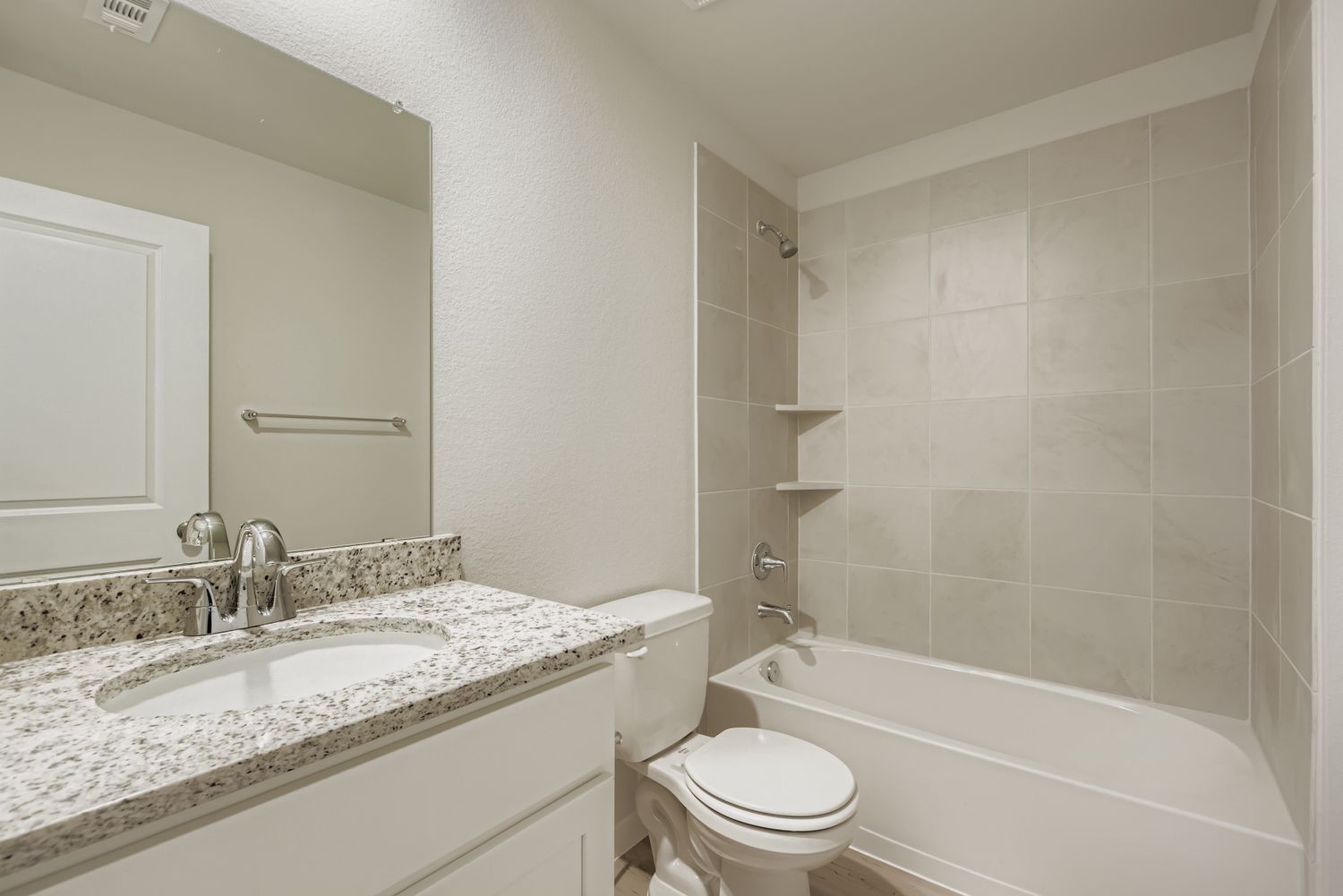 A bathroom with a tub sink and toilet.