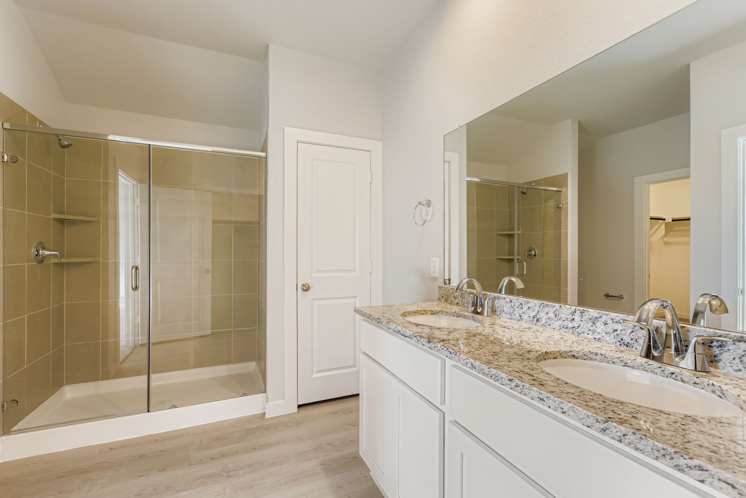 A bathroom with a large glass shower.
