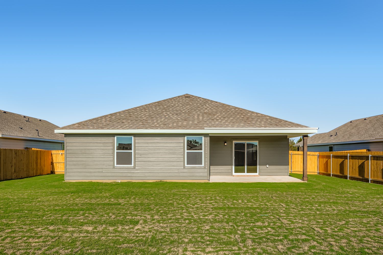 A house with a grass yard.