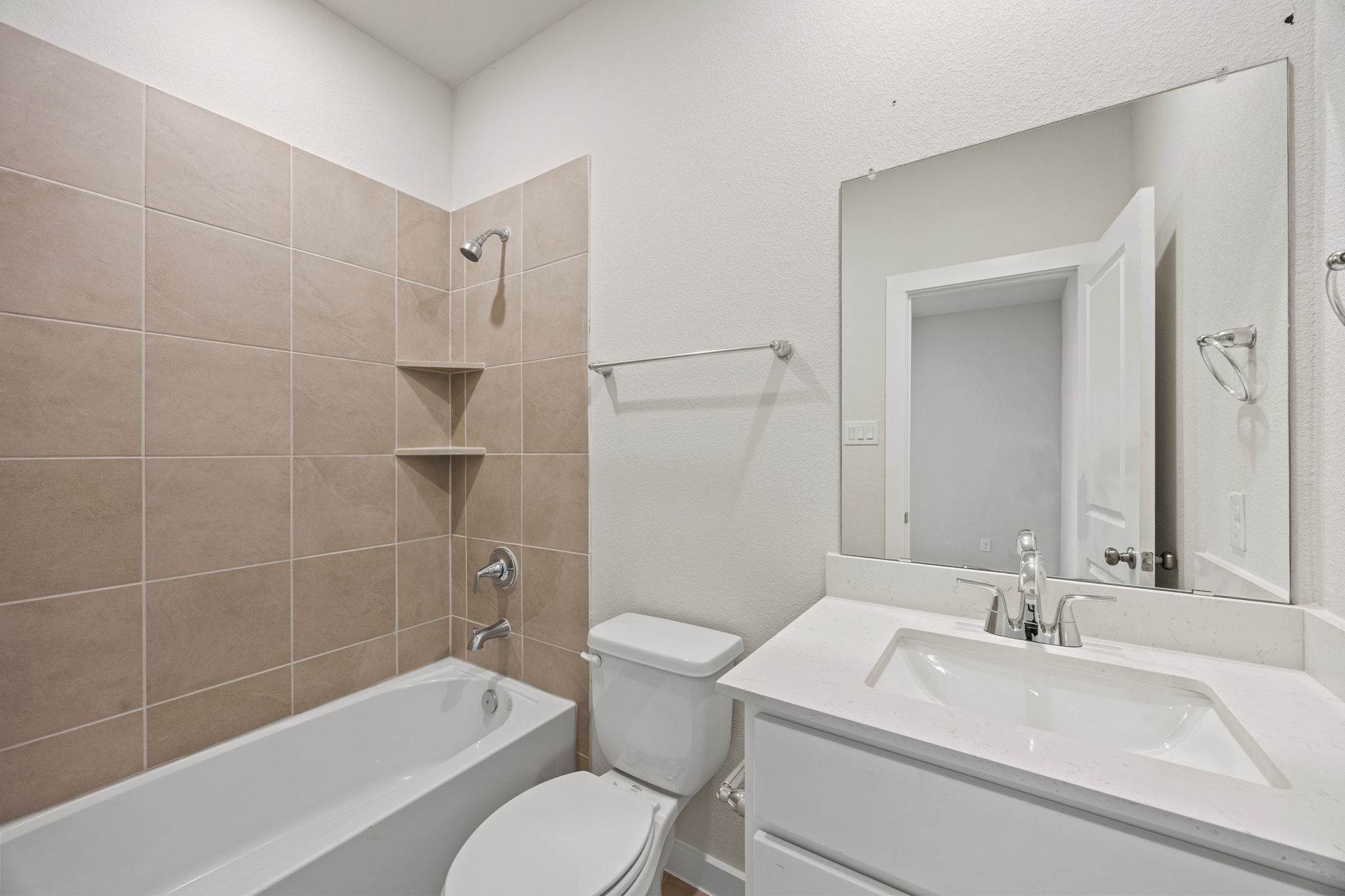A bathroom with a tub sink and toilet.