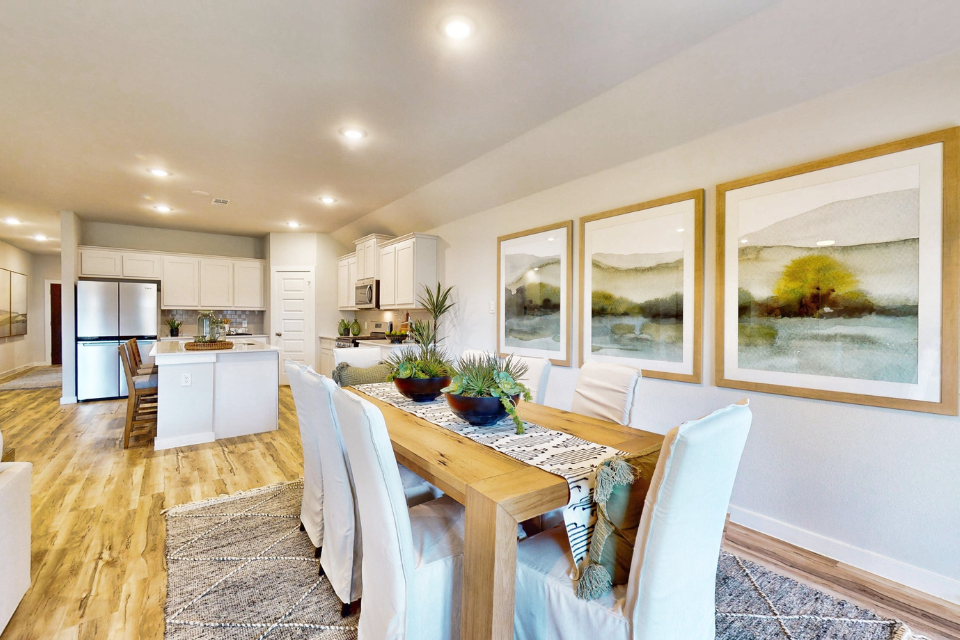 A kitchen with a dining table.