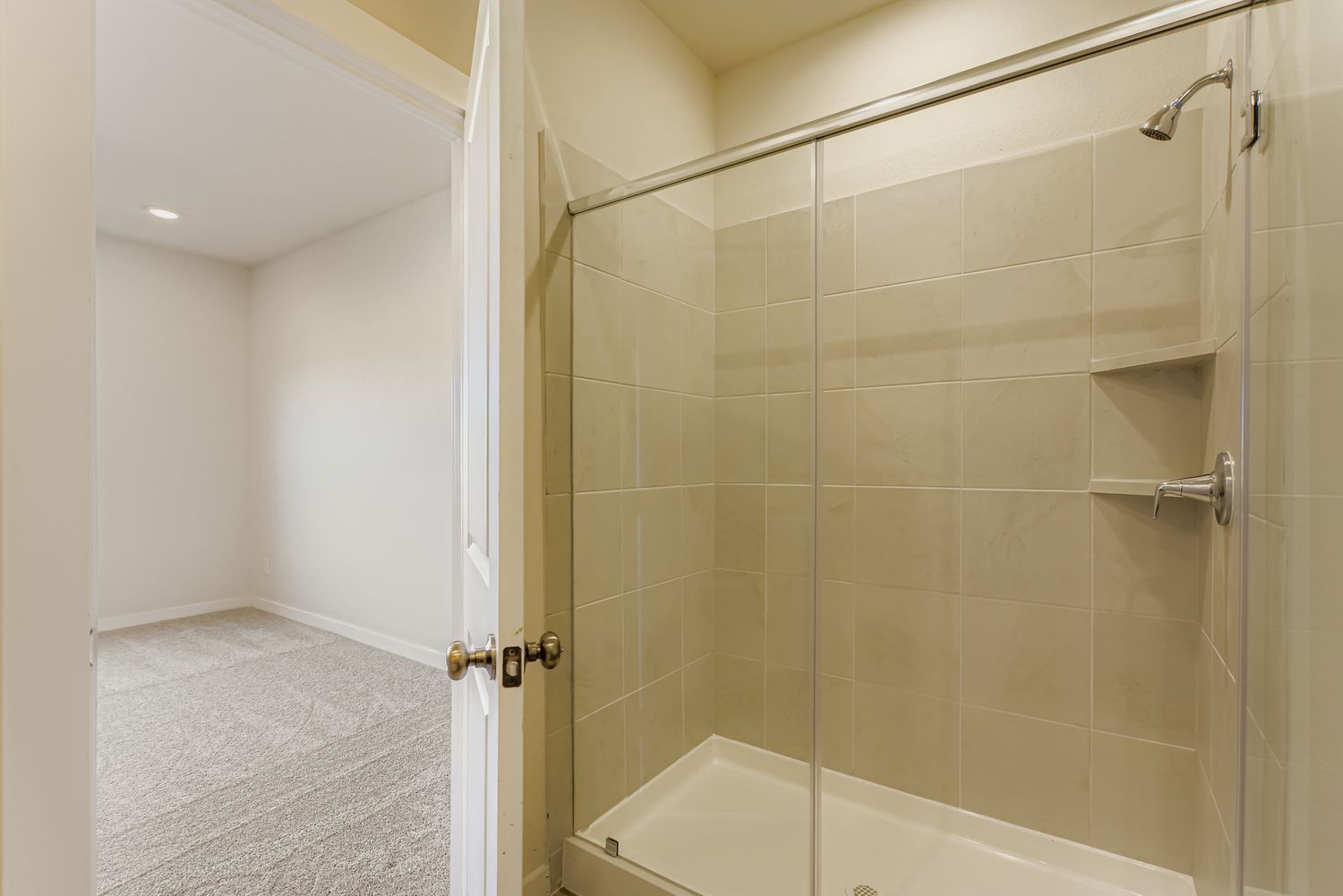 A bathroom with a shower unit.
