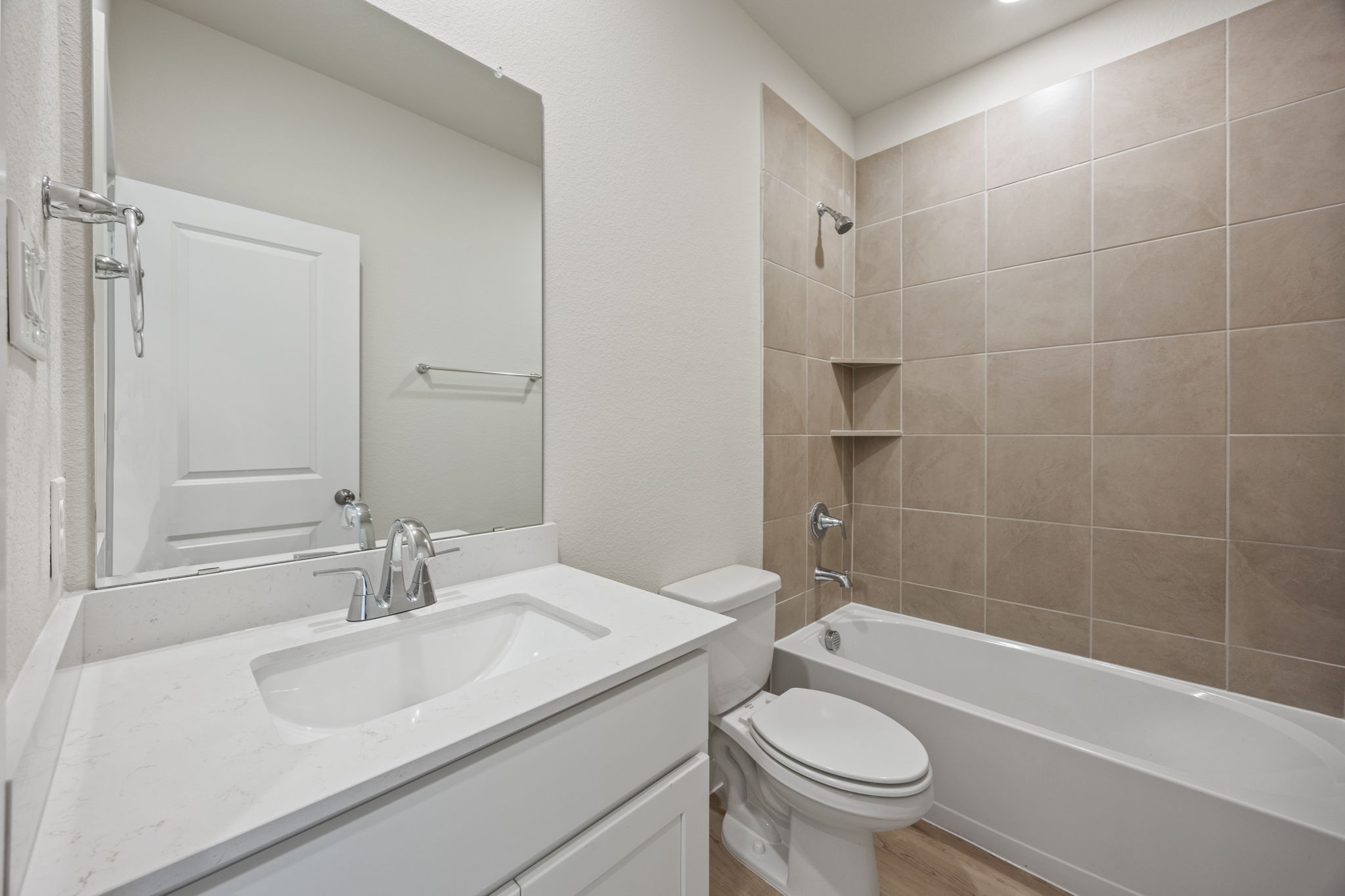 A bathroom with a sink toilet and bathtub.