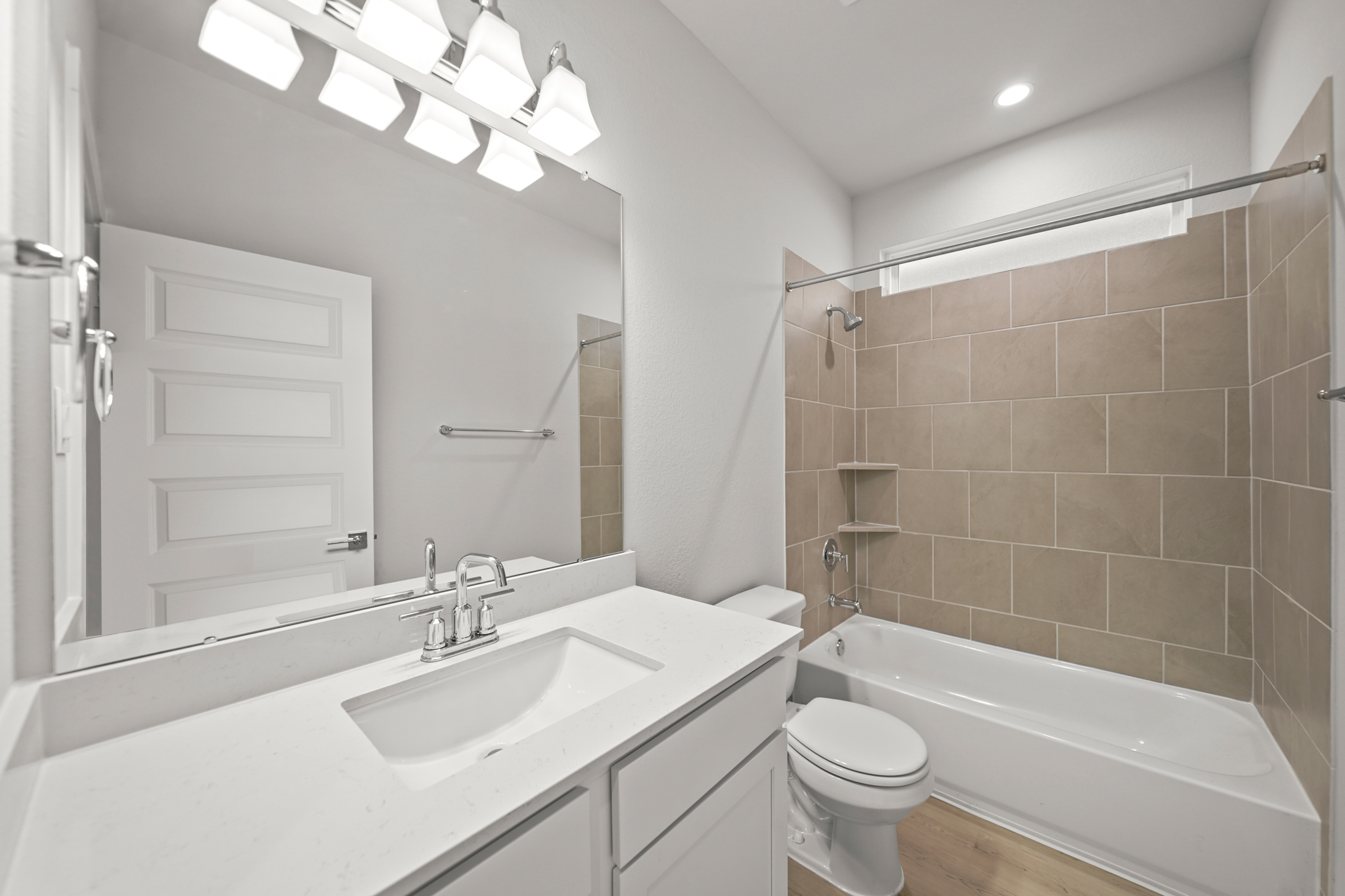 A bathroom with a tub sink and toilet.