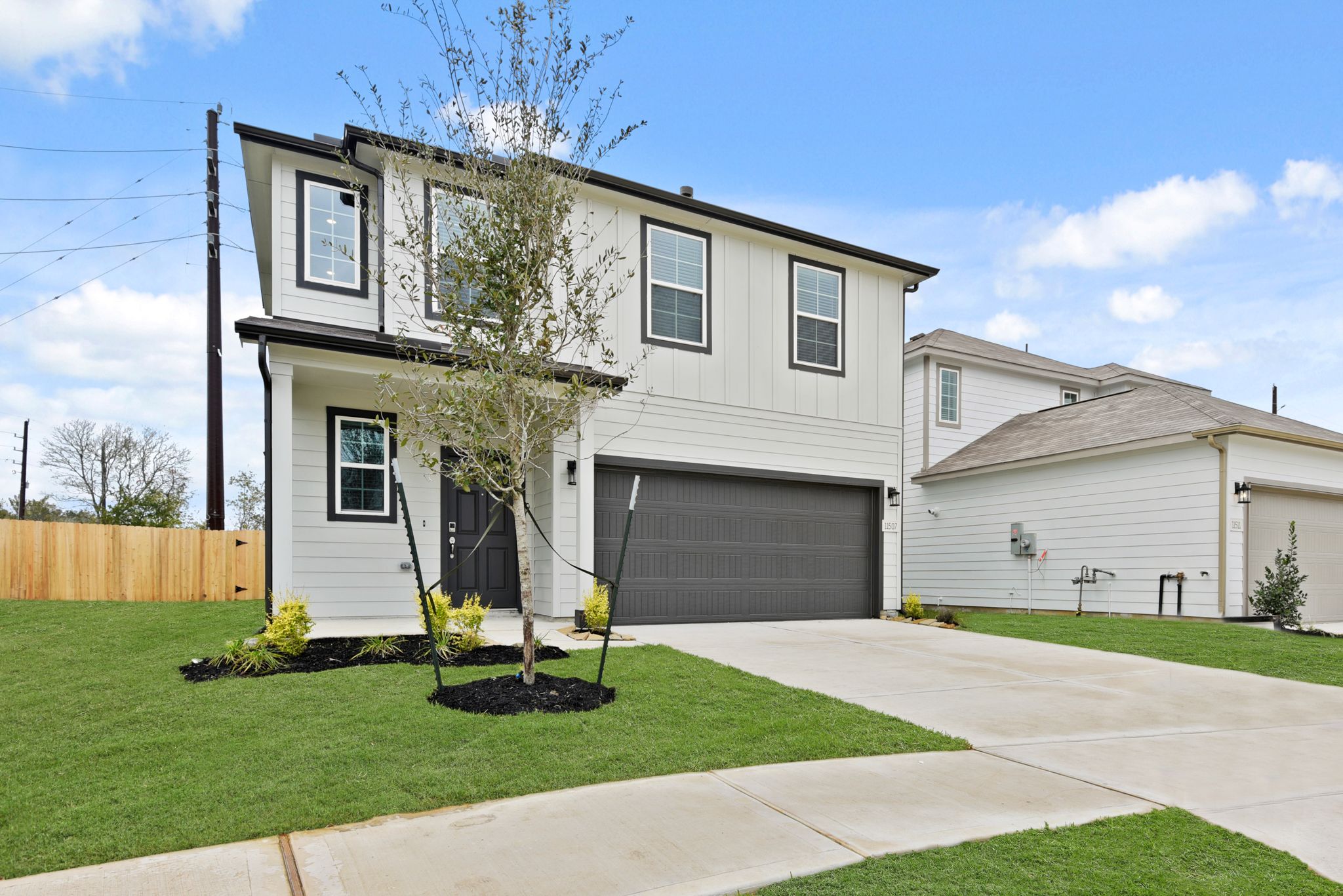 A house with a tree in the front yard.