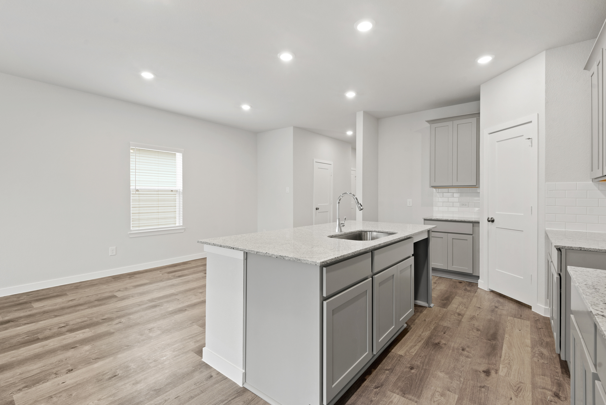 A kitchen with white cabinets.