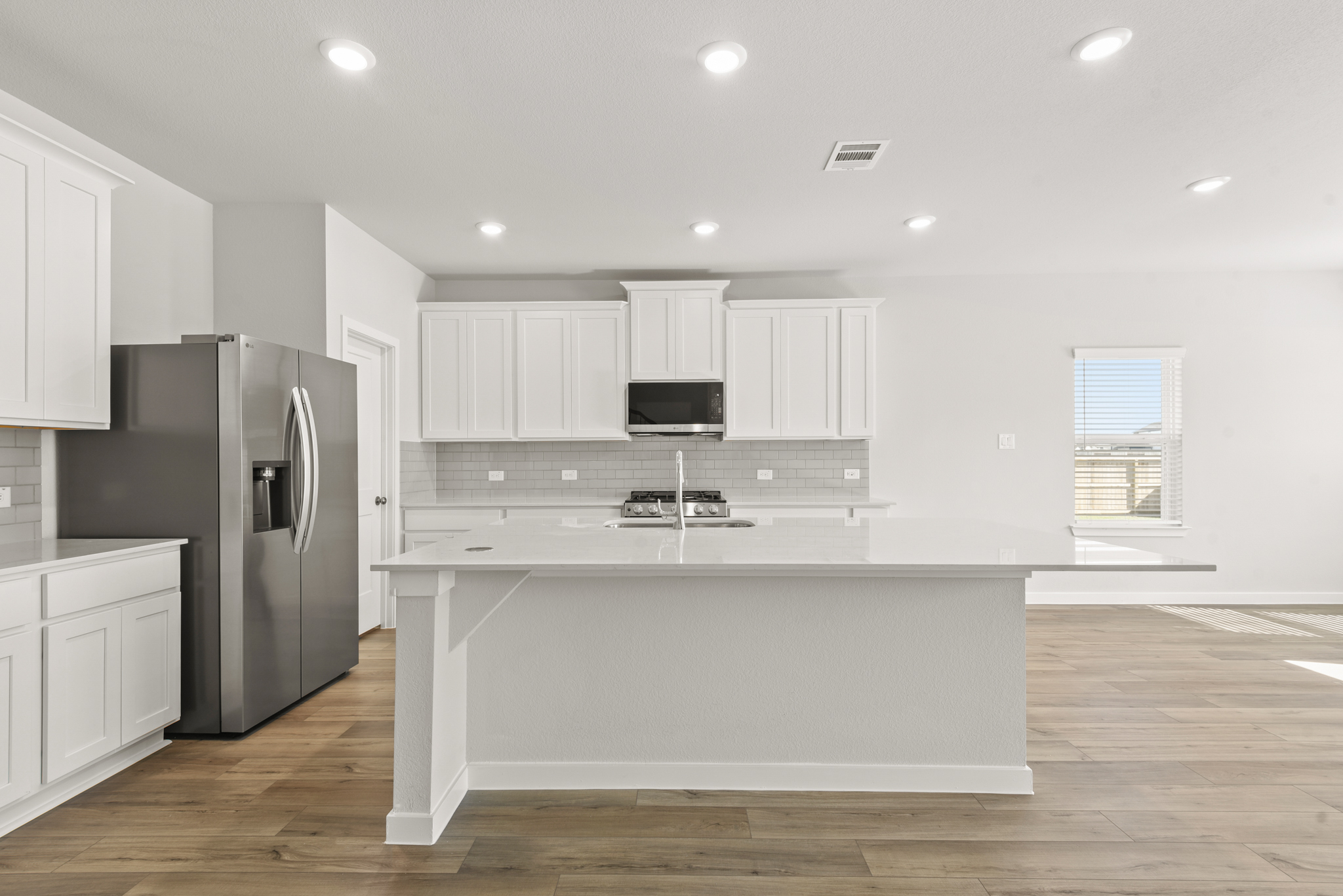 A kitchen with white cabinets.