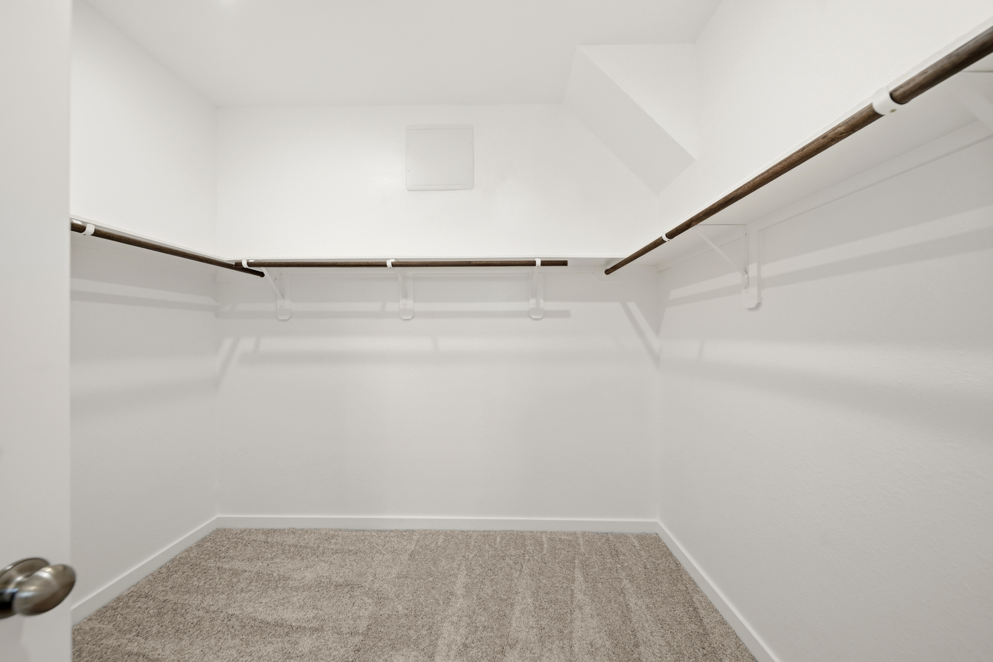 A white room with a carpet.