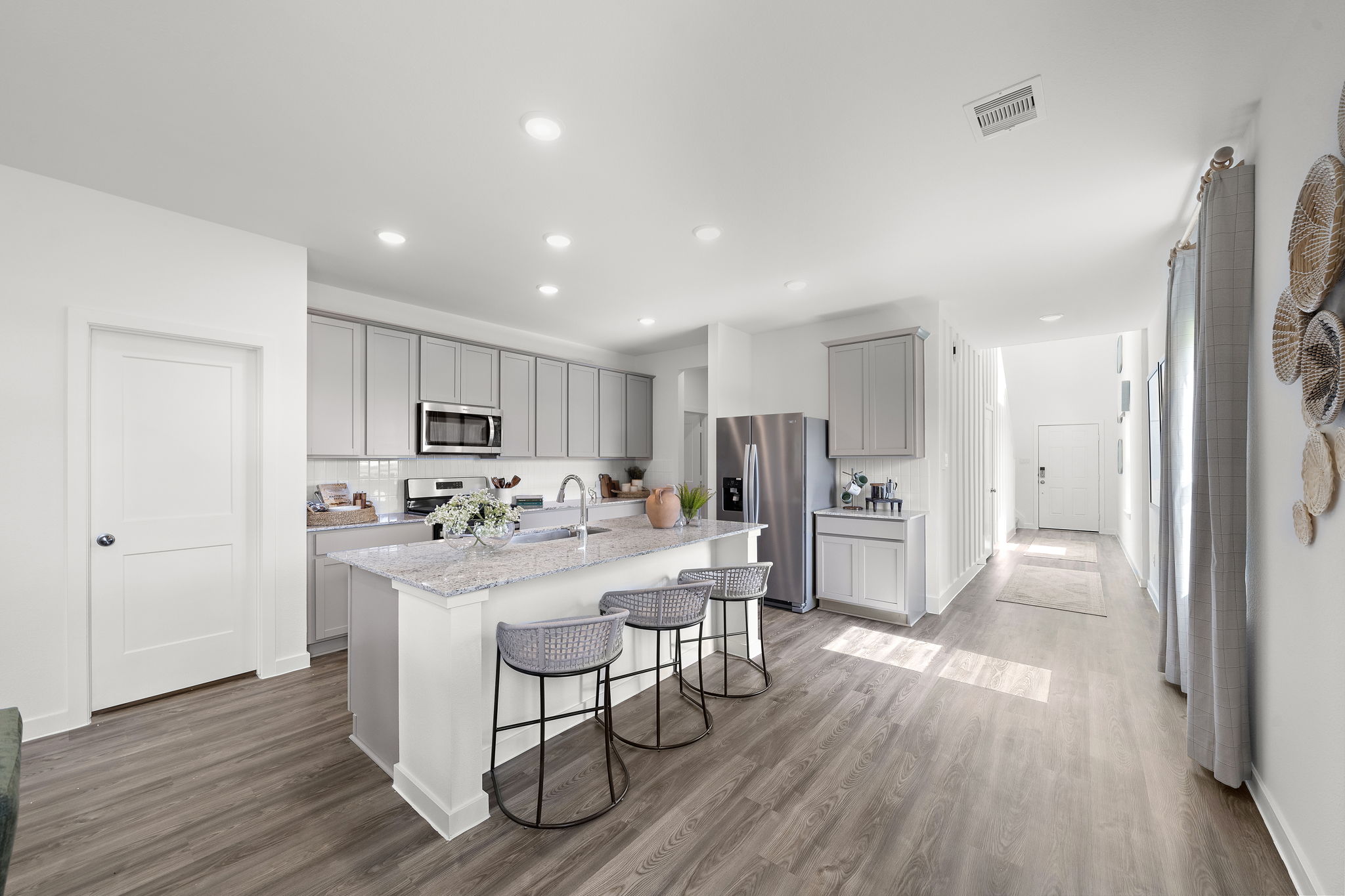 A kitchen with white cabinets.