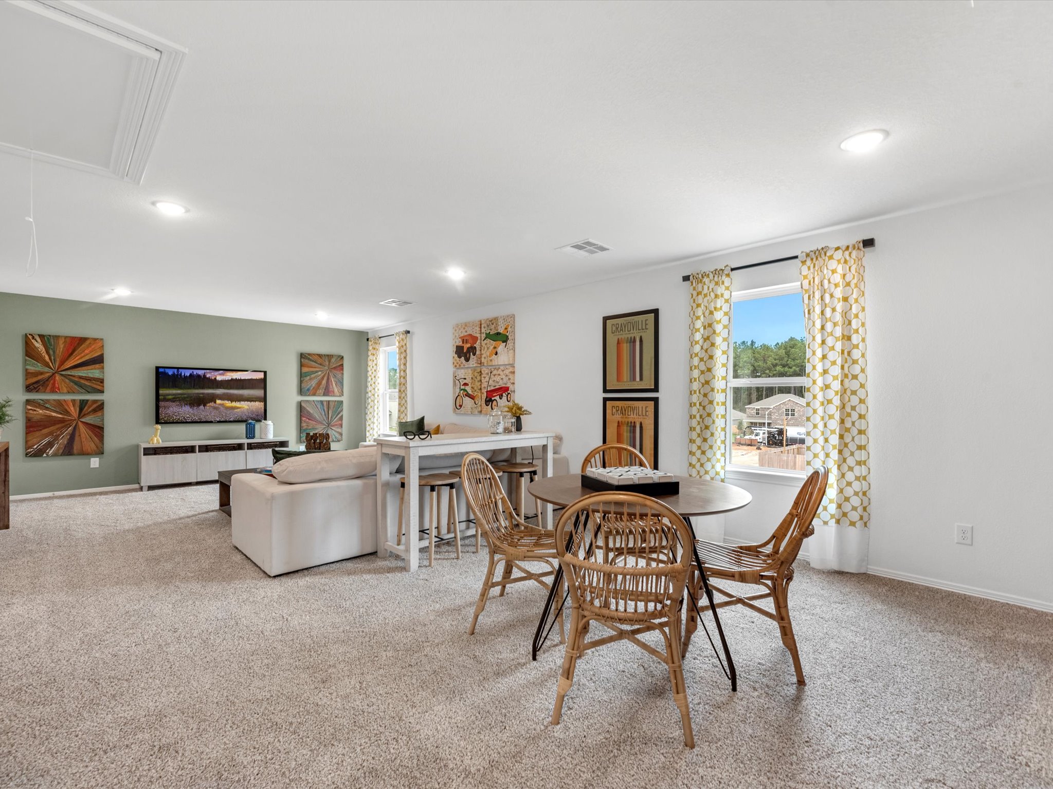 A large living room with a large dining table and couches.