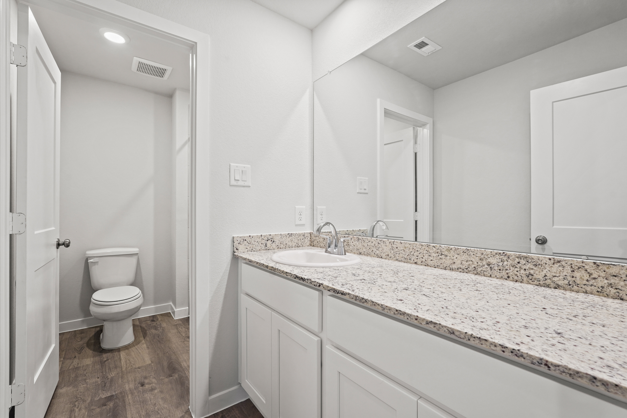 A bathroom with a marble countertop.