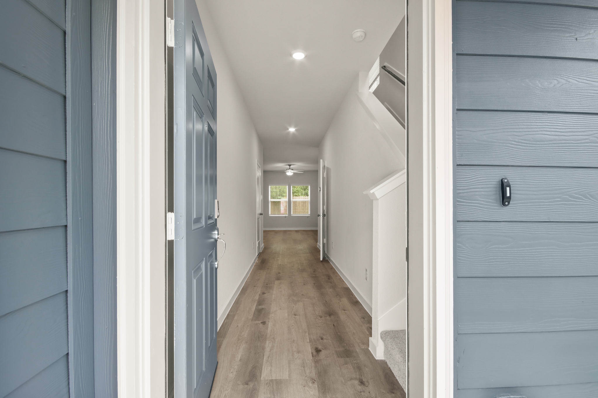 A hallway with white walls.