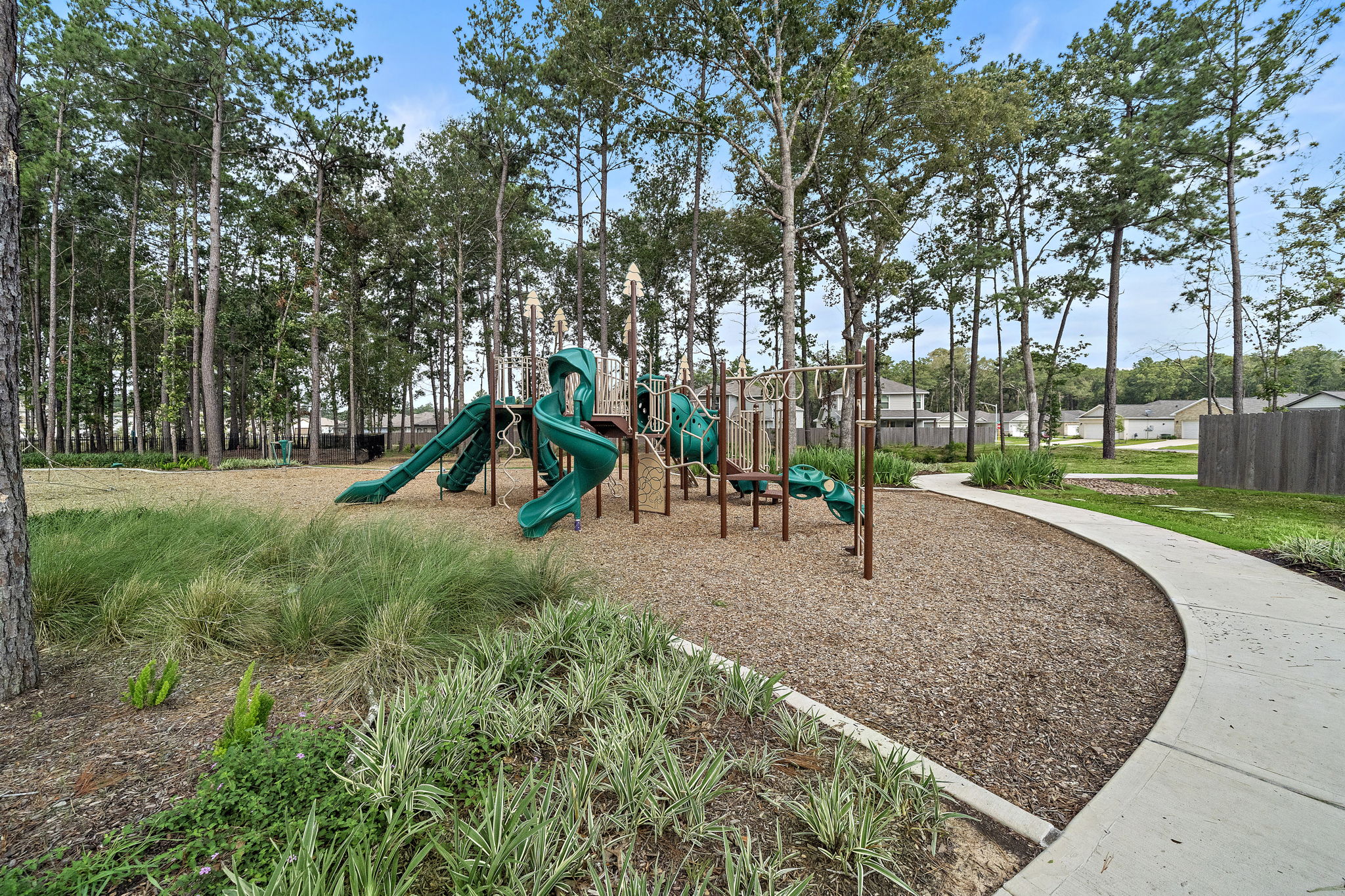 A playground with trees and grass.