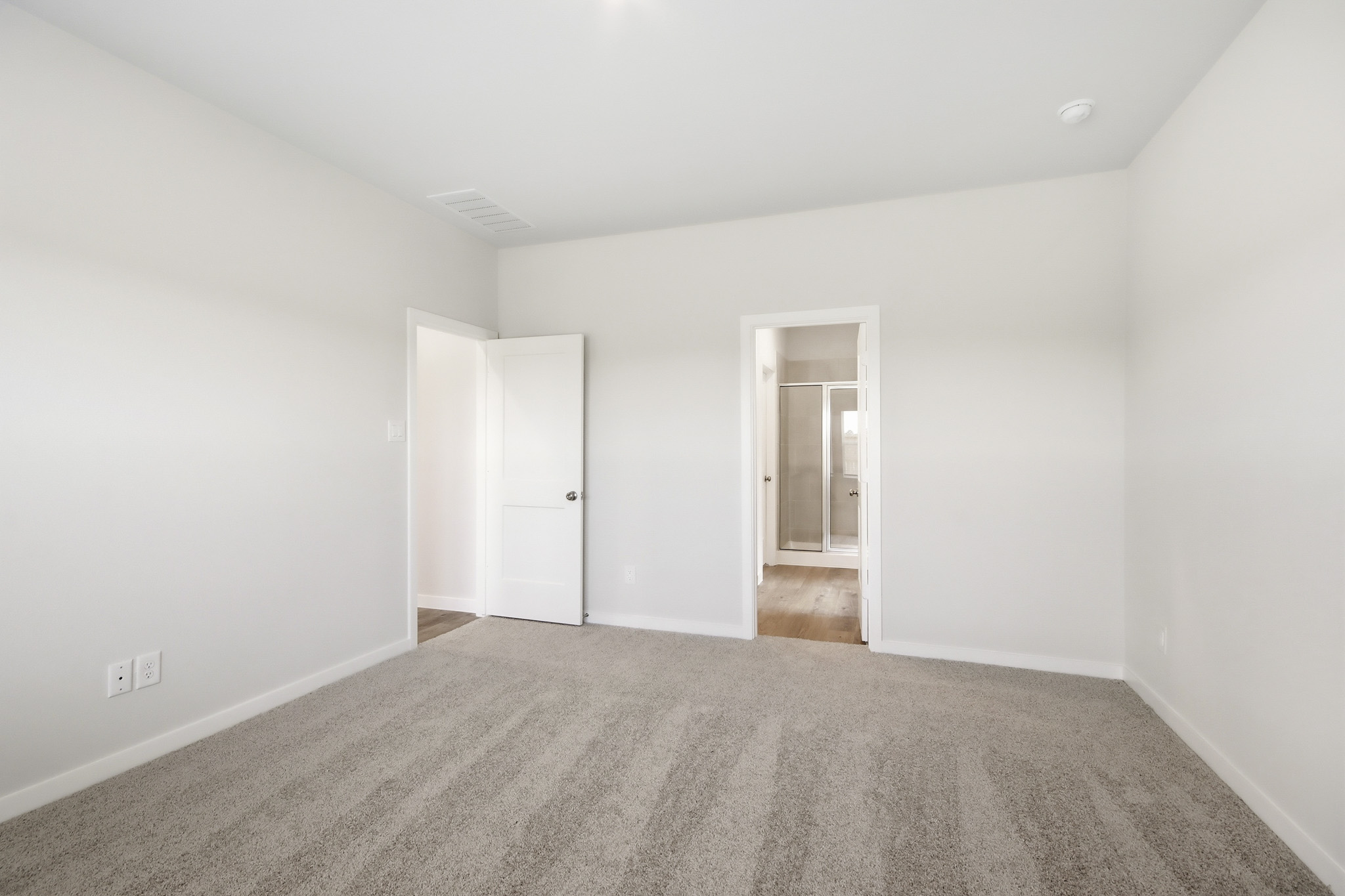 A hallway with white walls.