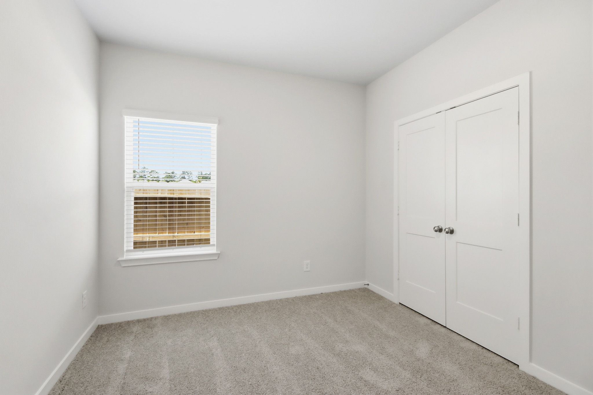 A room with white doors and a window.