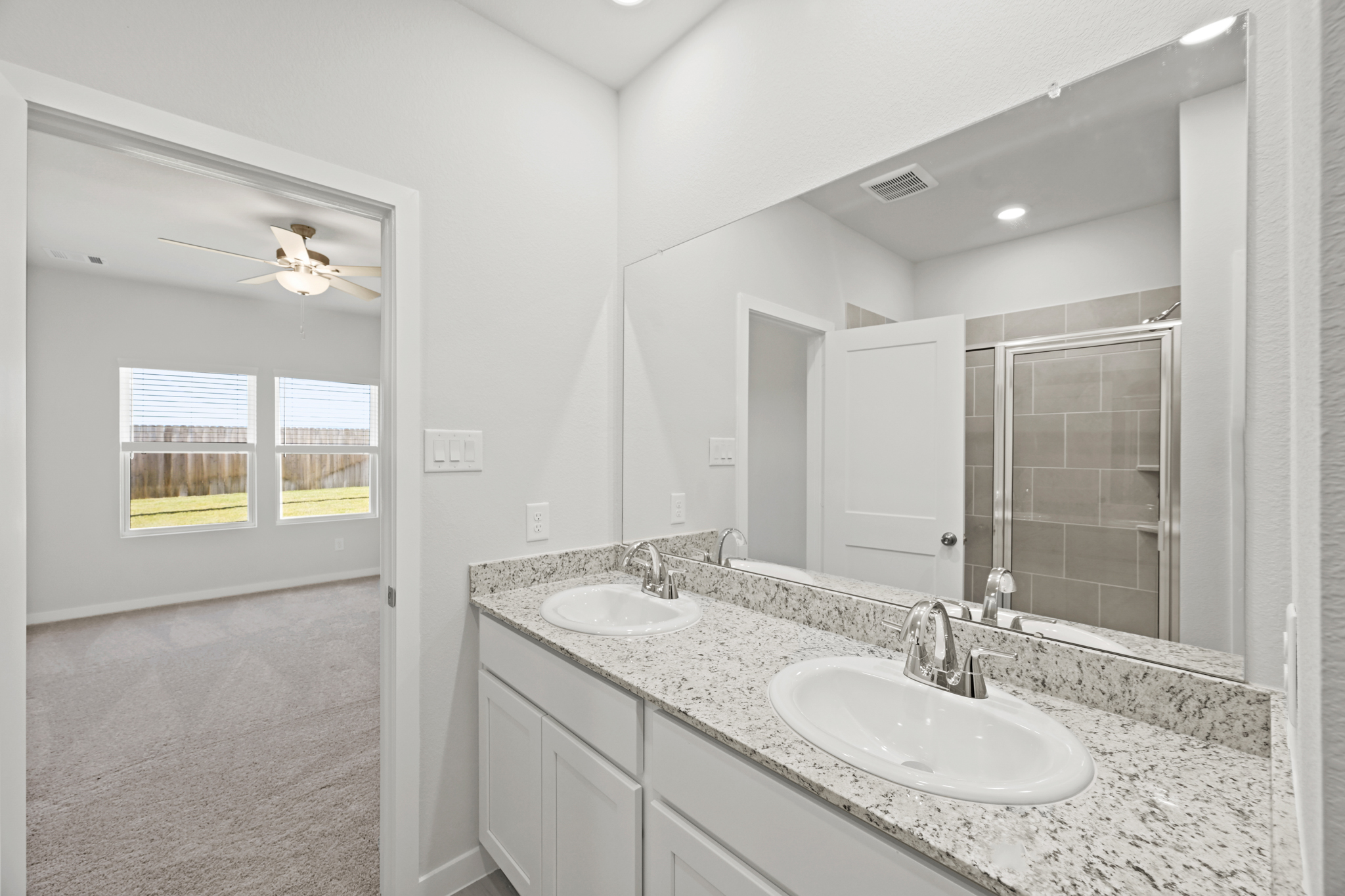 A bathroom with a large mirror.