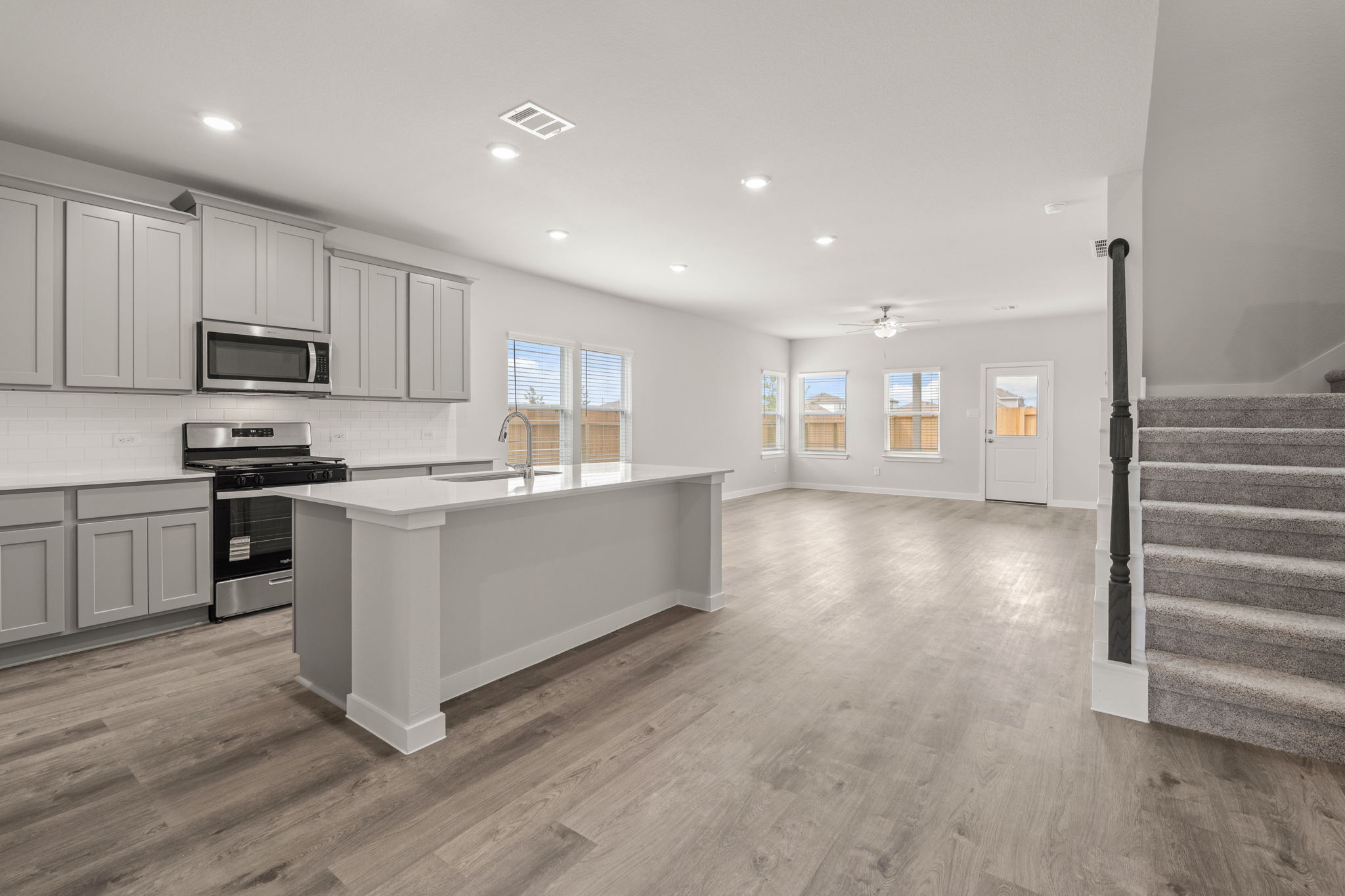 A large kitchen with white cabinets.