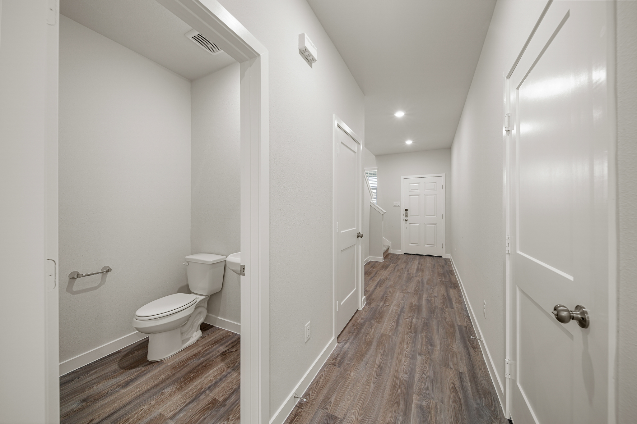 A bathroom with white walls.