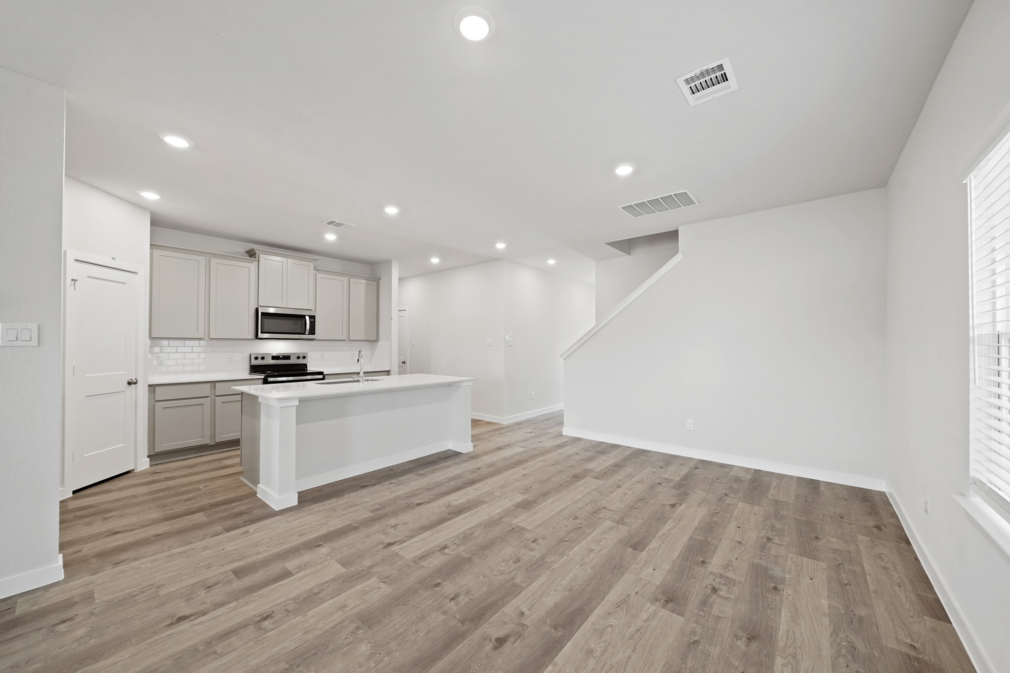 A kitchen with white cabinets.