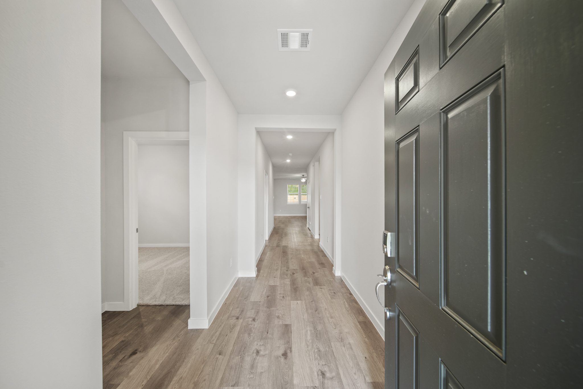 A hallway with black doors.