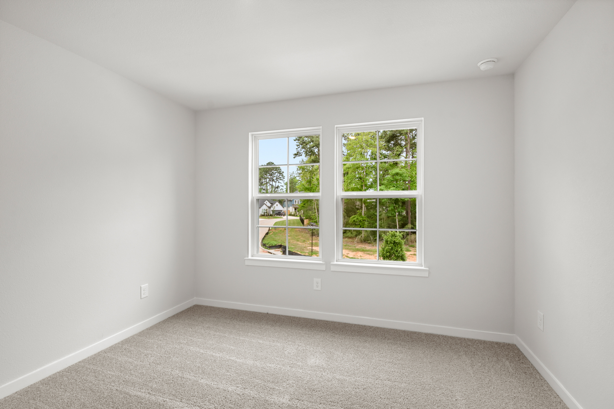 A room with a window and a carpet.