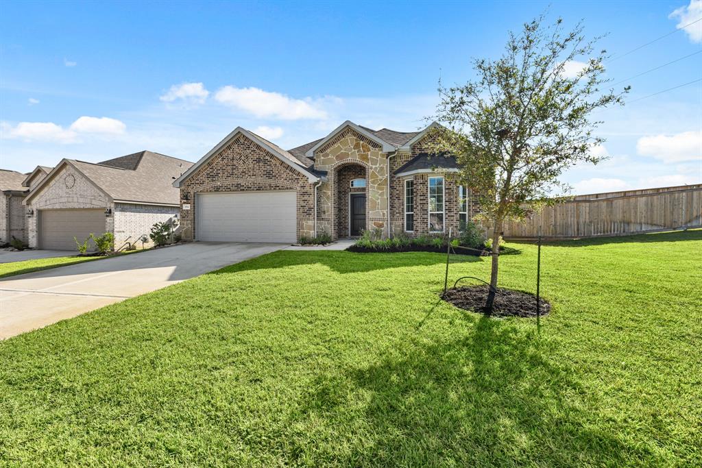 A large house with a tree in the front yard.