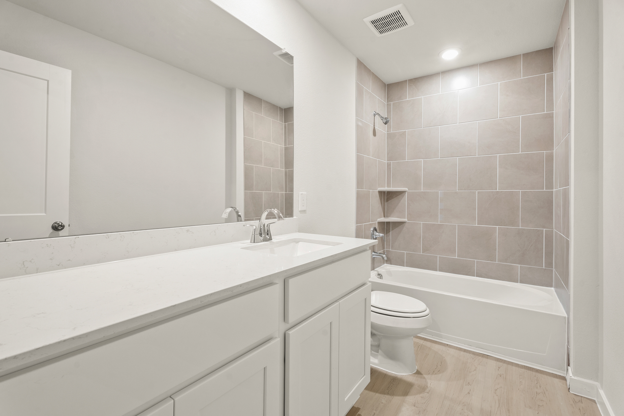 A bathroom with a tub toilet and sink.