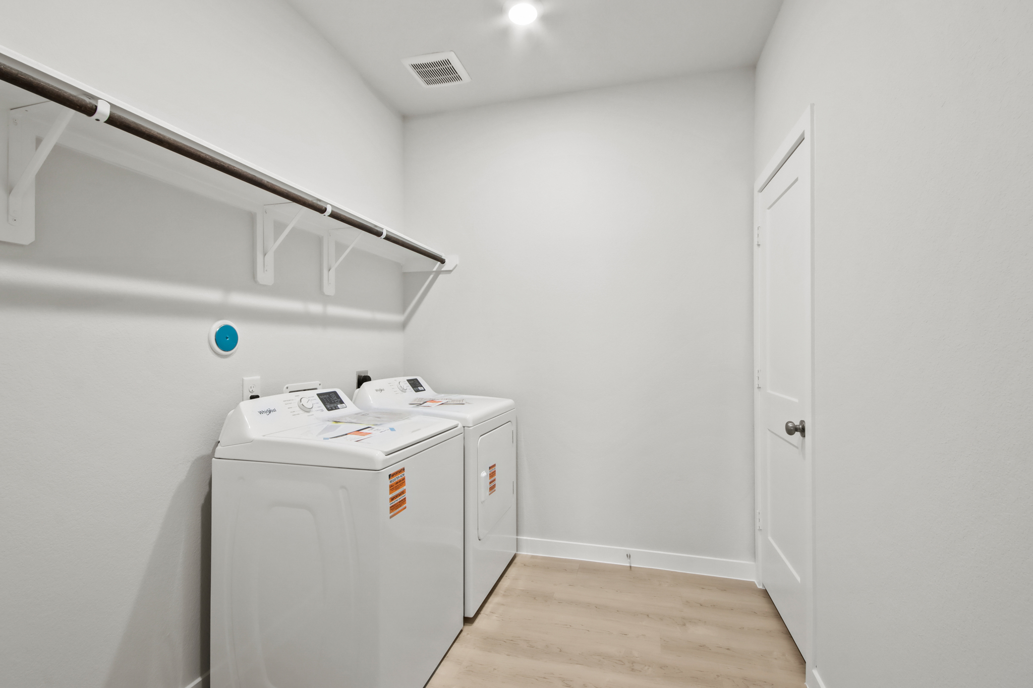 A room with a white wall and a white machine.