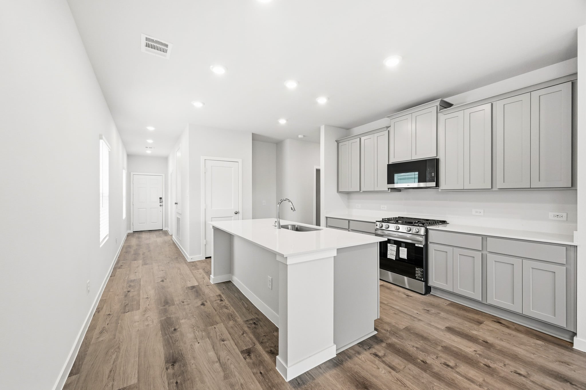 A kitchen with white cabinets.