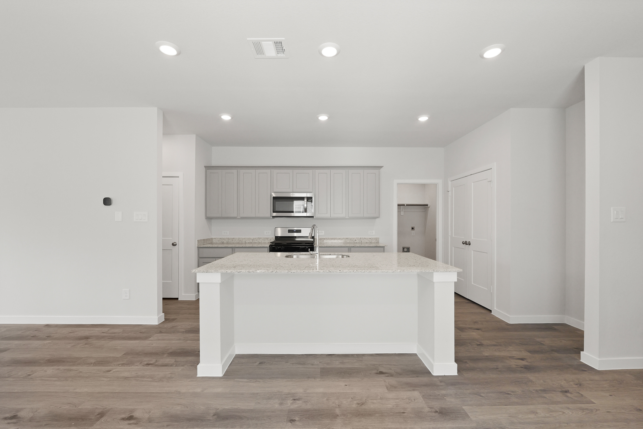 A kitchen with white cabinets.