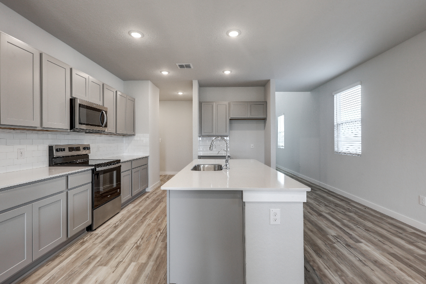 A kitchen with white cabinets.