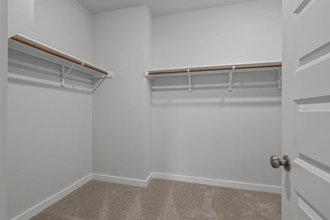 A white room with a metal bar.