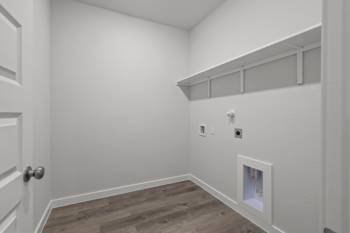 A white room with a wood floor.