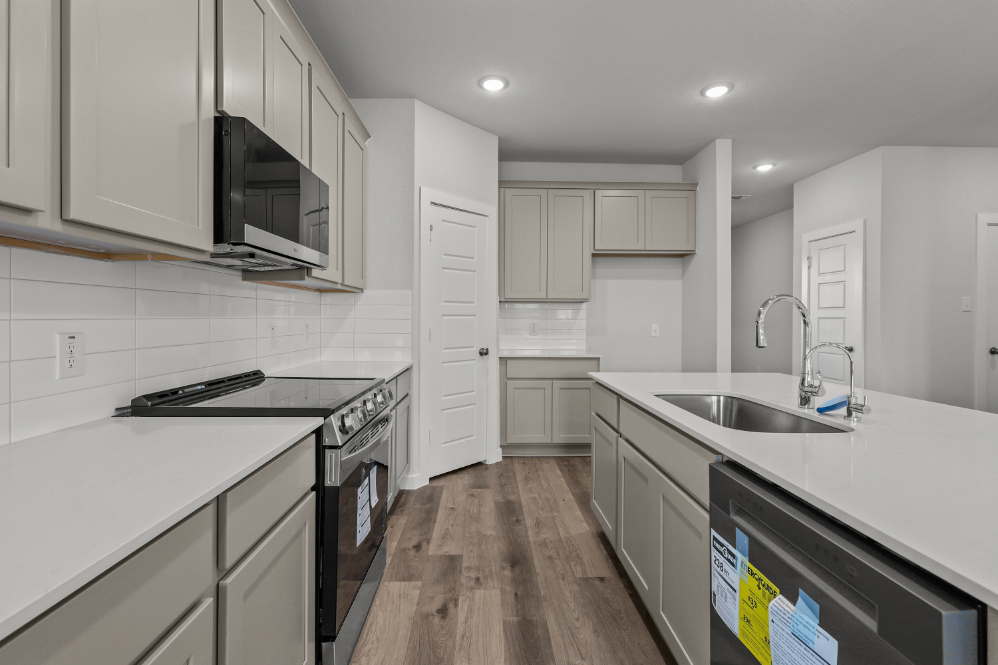 A kitchen with white cabinets.