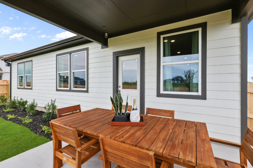 A table and chairs outside a house.