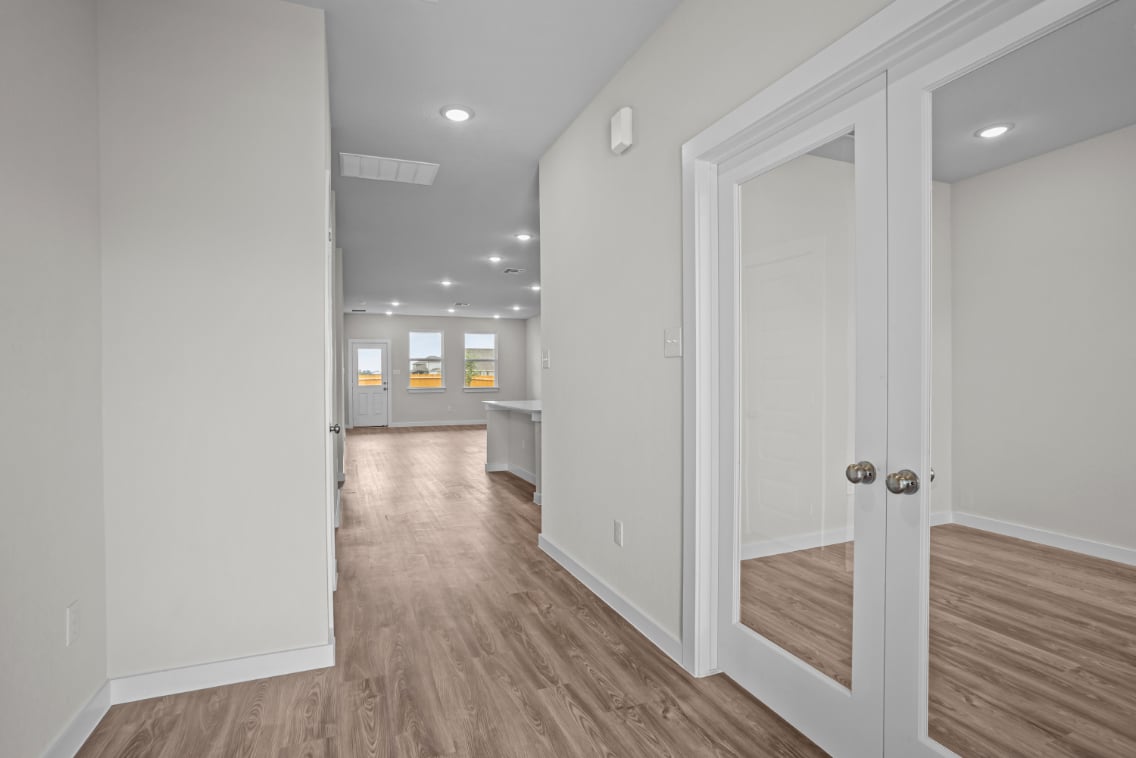 A hallway with white doors.