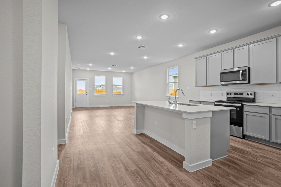 A kitchen with white cabinets.