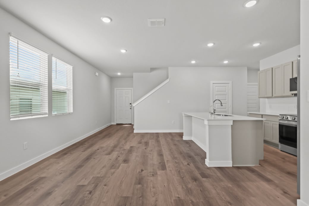 A kitchen with white cabinets.