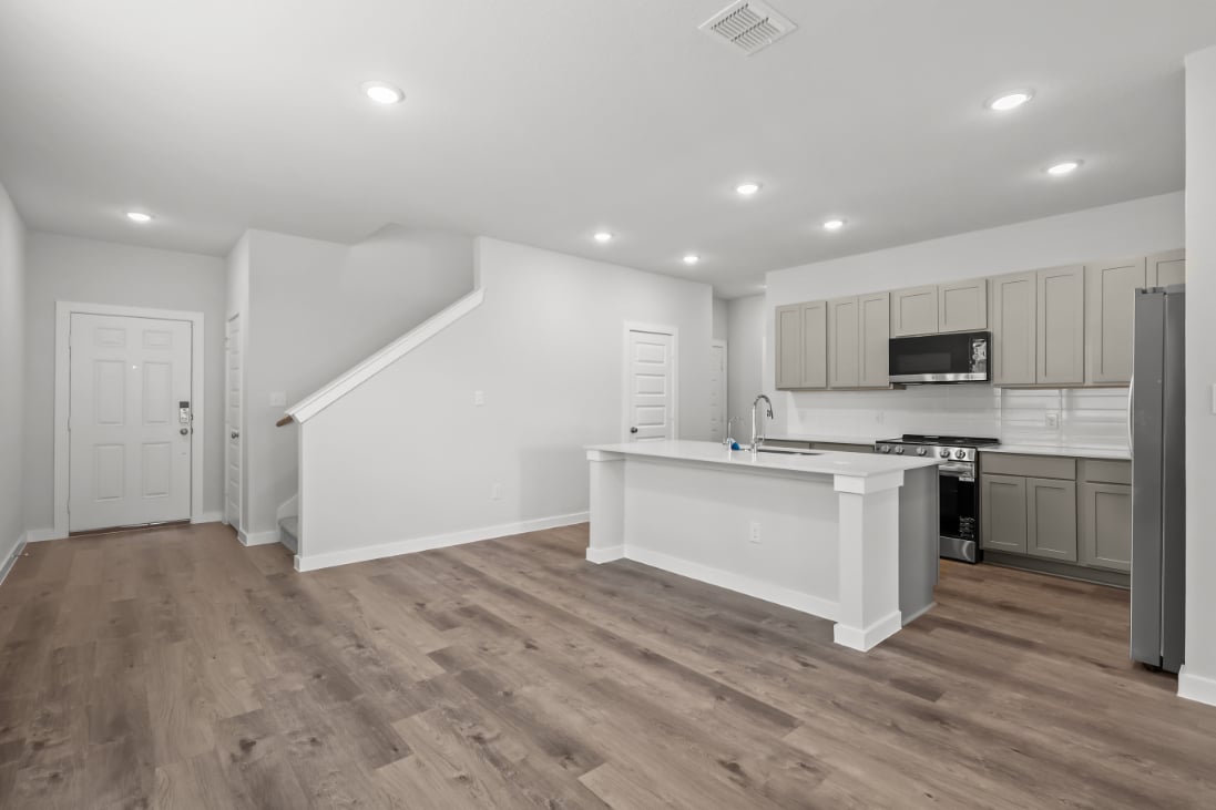 A kitchen with white cabinets.