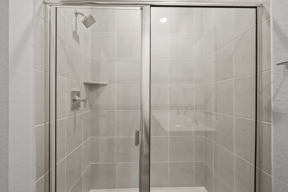 A shower with glass doors.