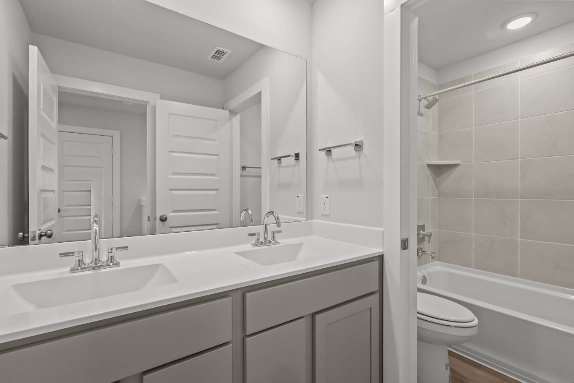 A bathroom with a sink and a toilet.