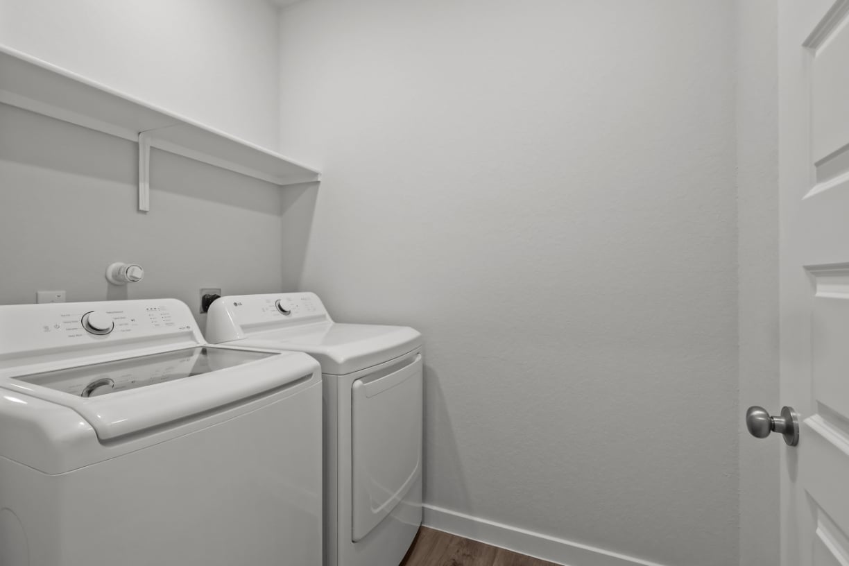 A washing machine in a room.