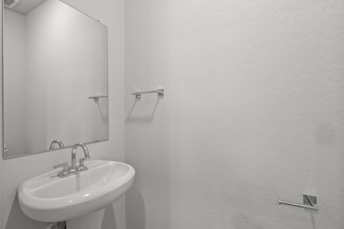 A bathroom with a mirror and sink.